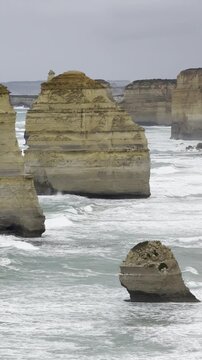 Powerful waves crashing against the limestone cliffs, stacks of the Twelve Apostles in Port Campbell National Park on the Great Ocean Road, Victoria, Australia