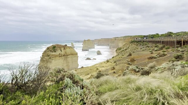 Powerful ocean waves crashing against the dramatic cliffs at the Loch Ard Gorge viewpoint near the Twelve Apostles on the Great Ocean Road, Victoria, Australia