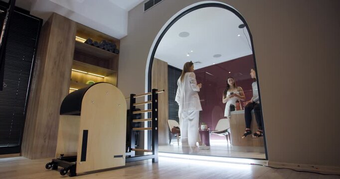 Friends gather at a modern wellness center to unwind and socialize. The inviting atmosphere enhances their time together as they share laughs and refreshments