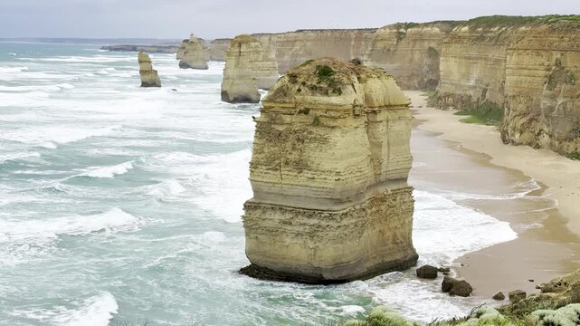 Powerful ocean waves crashing against the dramatic cliffs at the Loch Ard Gorge viewpoint near the Twelve Apostles on the Great Ocean Road, Victoria, Australia