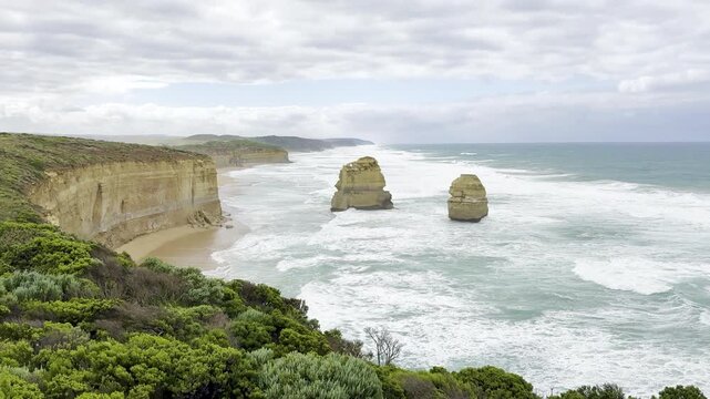 Powerful ocean waves crashing against the dramatic cliffs at the Loch Ard Gorge viewpoint near the Twelve Apostles on the Great Ocean Road, Victoria, Australia