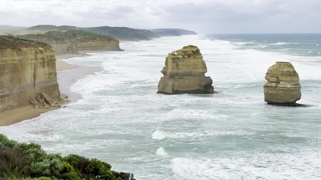 Powerful ocean waves crashing against the dramatic cliffs at the Loch Ard Gorge viewpoint near the Twelve Apostles on the Great Ocean Road, Victoria, Australia