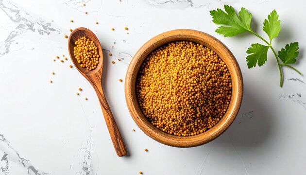Close-up of golden bee pollen granules in a wooden bowl with a spoon on a marble surface.