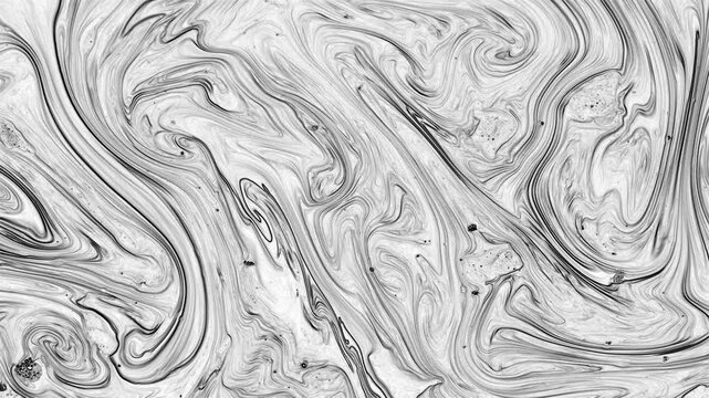 A complex blend of tight black ink swirls and delicate grey lines. These circular fluid patterns resemble a unique fingerprint or a detailed cross-section of a marble mineral.