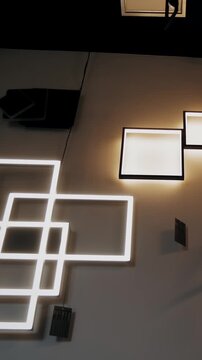 Lights switching on and off, chandeliers and wall lamps in store showroom