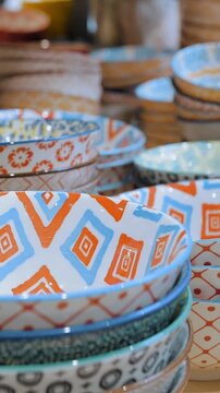 Sale of dishes in the store, multi colored ceramic plates, sets of dishes on display