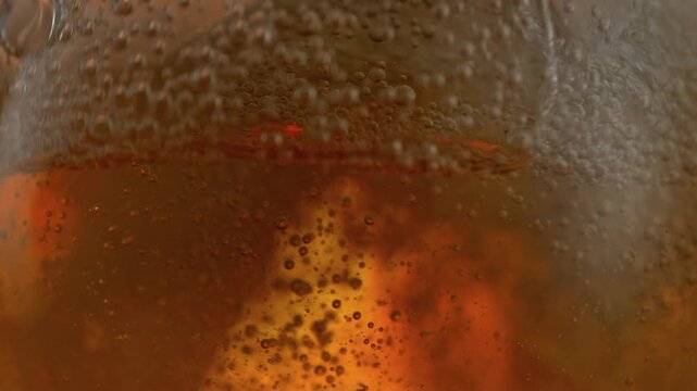 Super Slow Motion Shot of Rippling Fresh Beer With Bubbles at 1000fps.