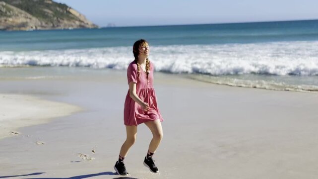 Happy girl runs along the stunning paradise Squeaky Beach with white sand and turquoise water in Wilsons Promontory National Park, Squeaky Beach Road, Yanakie, Victoria, Australia
