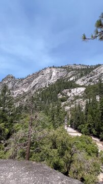 View of Mount Broderick from a trail summit in Yosemite National Park. Natural granite landscape and clear sky create a calm outdoor scene.