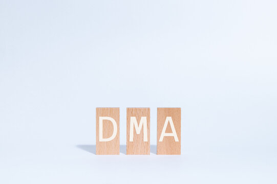 Eye-catching image of DMA text on wood blocks. The word stands for Digital Markets Act.