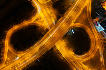 Aerial night view of Prague highway interchange at Spořilov with light trails from moving vehicles, captured in long exposure from a top-down drone perspective.  © Jan Valášek