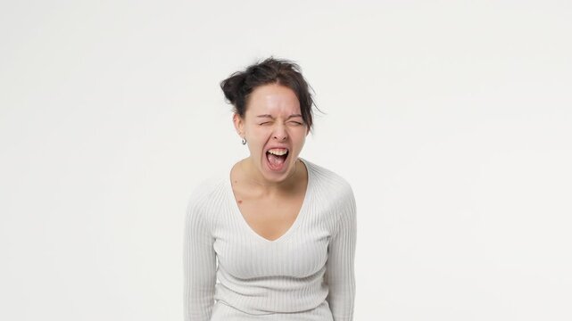 Adult young woman is angry shouting and swearing against a white background isolated space