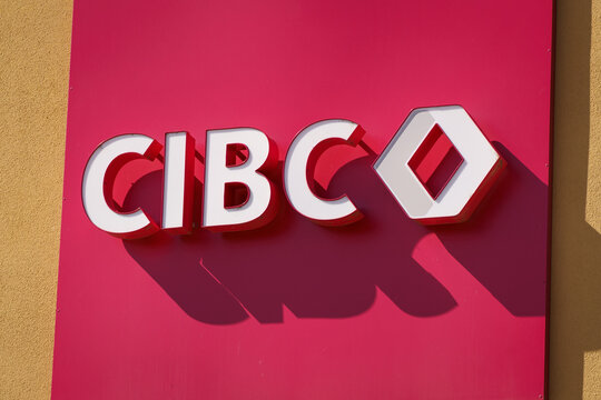 CIBC bank close up red and white logo on a tan coloured wall