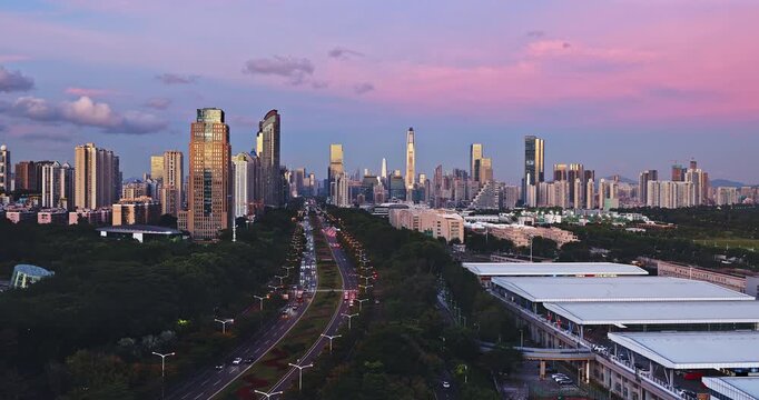 Modern city skyline and financial district with urban traffic at sunset, Shenzhen, China