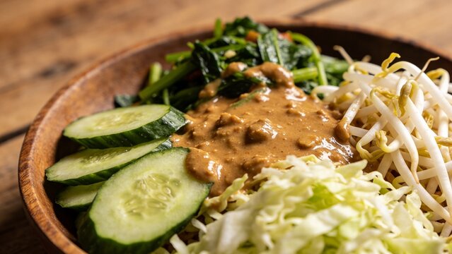 Traditional Indonesian Pecel Vegetables with Rich Peanut Sauce and Fresh Sliced Cucumbers