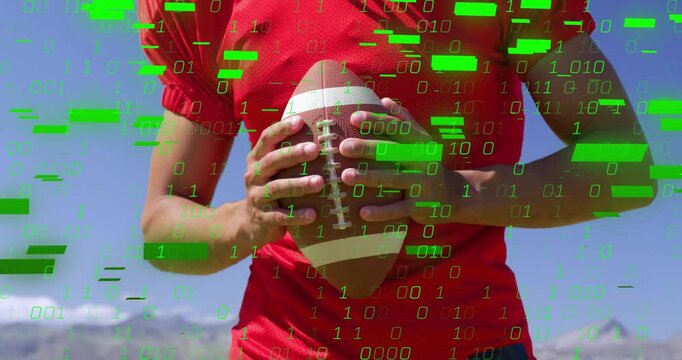 Torso holding football on cue green binary overlay appearing and multiplying, visualizing data flow
