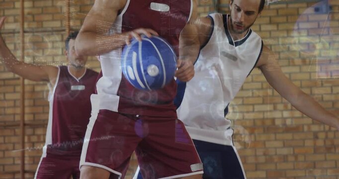 Male ball handler dribbling low on basketball court pivoting to protect ball as defender reaches