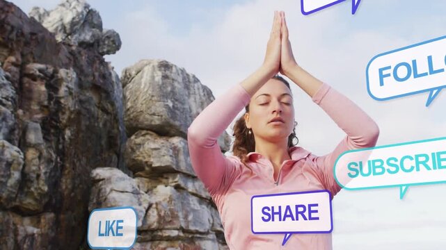 Woman practicing meditation on rocky cliff, social-media bubbles appearing and testing calm focus
