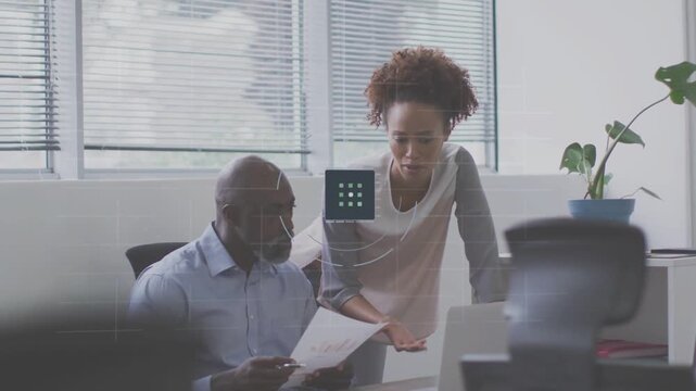 Mentor pointing paper causing translucent HUD as mentee aligning it to laptop for business review