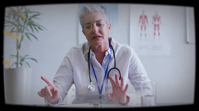 Senior dr reviewing file and explaining care, gesturing while growing yellow overlay sweeping face