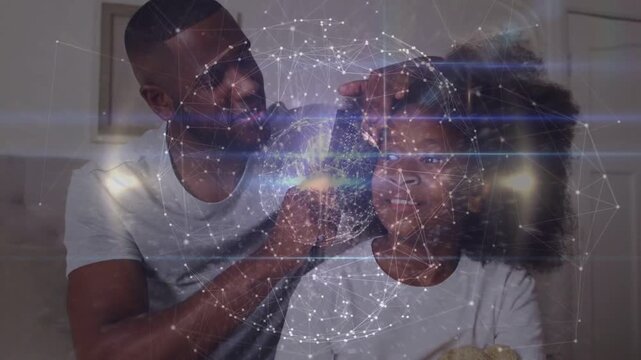 Father reaching over grooming daughter's hair for haircare using trimmer, globe overlay over faces