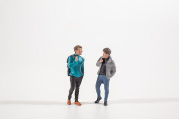 Fototapeta premium Miniature figures standing together in casual conversation