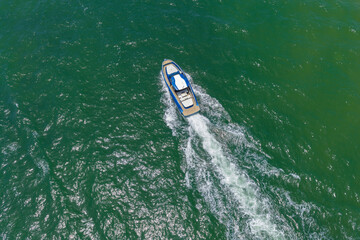 Fototapeta premium Luxury boat yachting. Motorboat sailing at sea. Luxury private yacht in sea. Motor yacht luxury vessel. Boat motor aerial. Vacation on summer. Aerial view on motorboat. Yacht boat tour