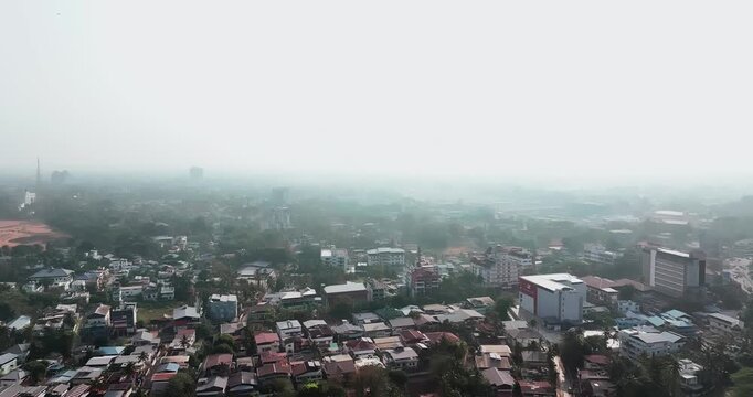 Aerial view of car traffic at the roundabout, lane and buildings in Thiruvananthapuram, Kerala, India. Beautiful cinematic shot of an Indian City.