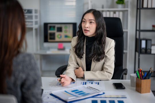 Businesswoman discussing financial data with client in office