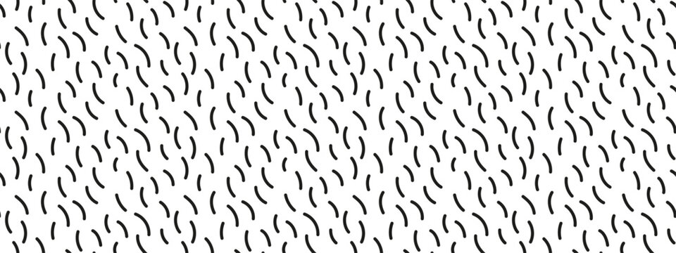 Seamless pattern of black curved dashes on white background. Thin curved brush strokes scattered randomly on white background. Abstract minimal doodle texture