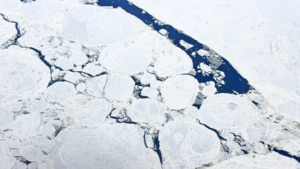 Aerial view of glacier ice and dark blue water. Abstract nature texture for climate change concept. © 石原圭二