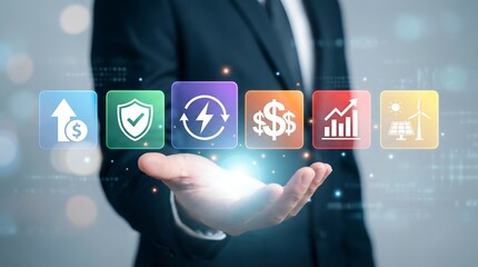 Obraz premium A businessman's open palm displays a row of glowing, colorful square icons representing diverse financial growth, energy solutions, and investment concepts, amidst a digital backdrop.