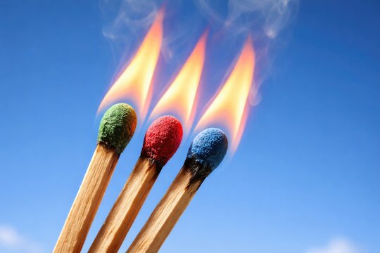Bright Safety Matches Burning Against Clear Blue Sky