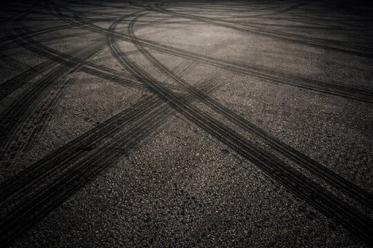 Asphalt surface with tire skid marks and copy space for design