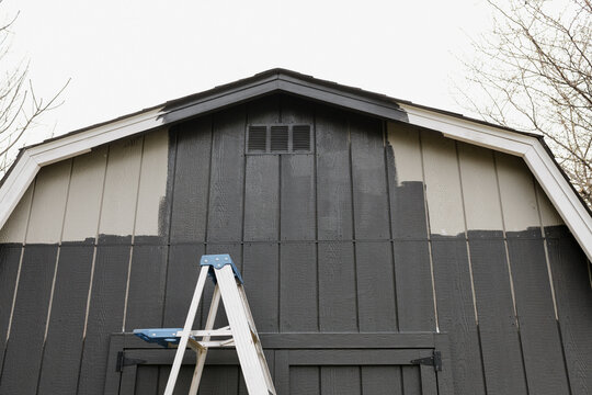 Updating an old barn with a dark grey paint color. 