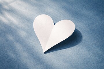 Fototapeta premium Heart Shaped Paper Cutout on Blue Background with Soft Daylight