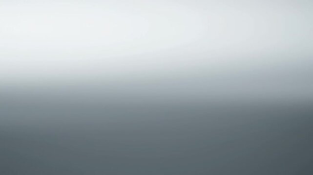 Abstract smooth gradient background in shades of gray and white.