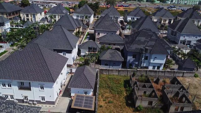 Beautiful aerial of new luxury homes with large courtyards in a suburban neighborhood in Abuja, Nigeria on a sunny day