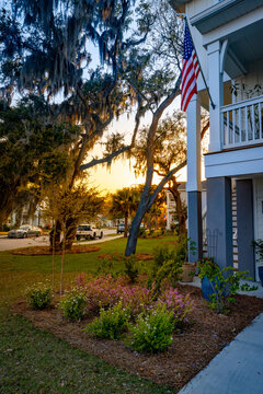 American flag on coastal home at sunset in trendy South Carolina neighborhood