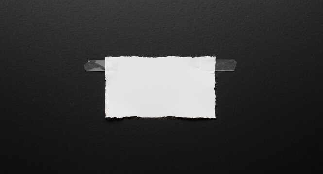 White torn sheet stuck to black surface with translucent tape showing copy space