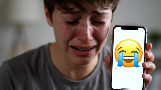Crying Young Man Holding Phone Showing Laughing Crying Emoji