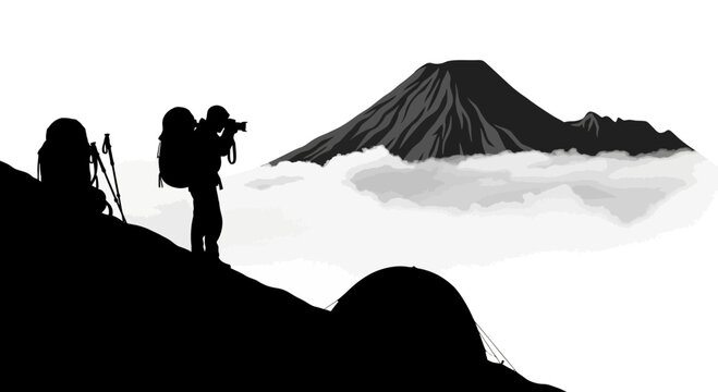 Silhouette of a hiker photographing a mountain peak above the clouds
