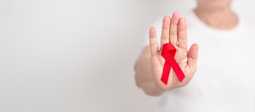 Elderly with Red Ribbon for December World Aids Day, MADD, October Red ribbon week, February Heart month, Marfan Syndrome, May Stroke awareness, March world TB Tuberculosis day and April Dare day