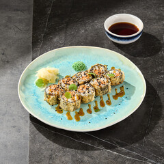 Tempura salmon maki roll with spicy sauce, bright lighting, overhead composition © Ryzhkov