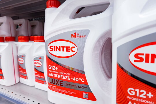 Sintec G12+ antifreeze in red and white containers displayed on a shelf in a store