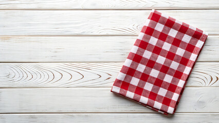Obraz premium Red and white gingham checkered cloth on light wooden table surface