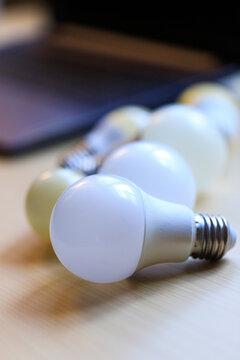 LED Light Bulbs on Wooden Table with Soft Focus Background