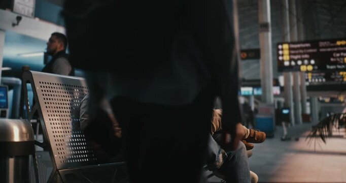 Mother With Two Children Sits on Airport Benches, Breastfeeding Small Baby and Holding Travel Documents. Normalization of Public Breastfeeding, Maternal Care, and Reality of Traveling With Infants.