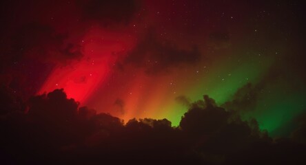 Fototapeta premium Glowing red and green hues brighten a dark cloudy night sky with vivid colors