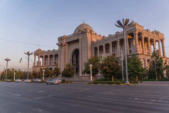Ismoil Somoni Avenue in Dushanbe, Tajikistan, with Navruz Palace at sunset with grand architecture and a wide empty boulevard.
